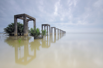 Gray Concrete Arches on Body of Water Under White Skies Gray Concrete Arches on Body of Water Under White Skies