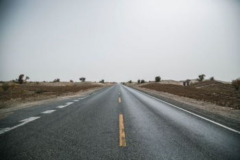 gray concrete road near gray soil