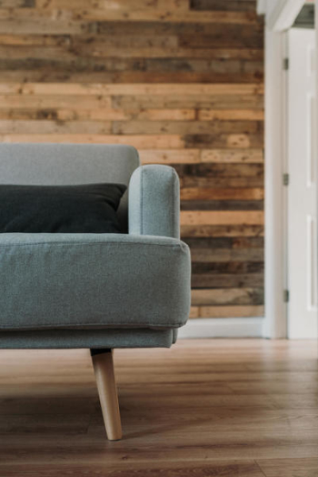 Gray Fabric Sofa Near White Wooden Wall Gray Fabric Sofa Near White Wooden Wall