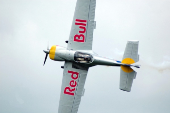 Gray Red Bull Monoplane on Mid Air Gray Red Bull Monoplane on Mid Air