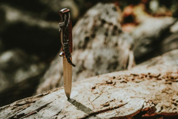 gray steel knife with brown handle gray steel knife with brown handle