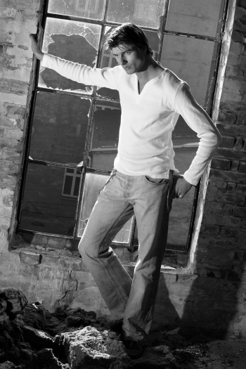 Grayscale Photo Of A Male Model By A Broken Window Grayscale Photo Of A Male Model By A Broken Window