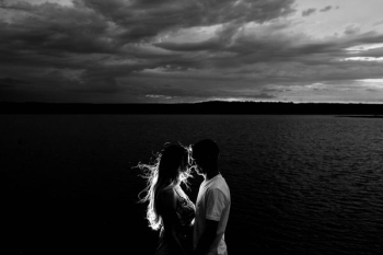 grayscale photo of couples near body of water grayscale photo of couples near body of water