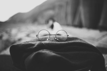 grayscale photo of hippie eyeglasses on cloth grayscale photo of hippie eyeglasses on cloth