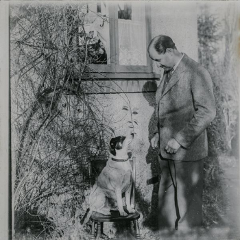 grayscale photo of man and dog grayscale photo of man and dog