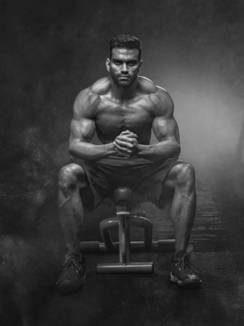 Grayscale Photo of Man Sitting on Bench Grayscale Photo of Man Sitting on Bench