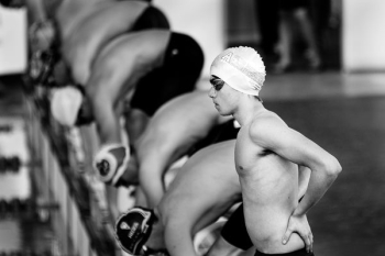 grayscale photo of swimmers about to dive grayscale photo of swimmers about to dive