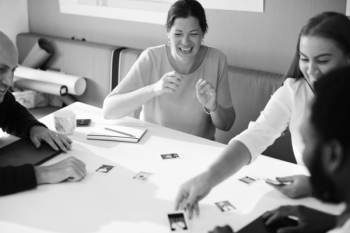 Grayscale Photography of Four Person Having A Discussion