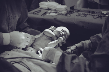 Grayscale Photography of Unknown Person Carrying Newborn Baby Grayscale Photography of Unknown Person Carrying Newborn Baby
