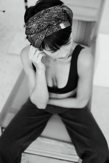 grayscale photography of woman sitting on chair grayscale photography of woman sitting on chair