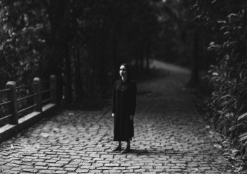 Grayscale Photography of Woman Standing on Brick Road Grayscale Photography of Woman Standing on Brick Road