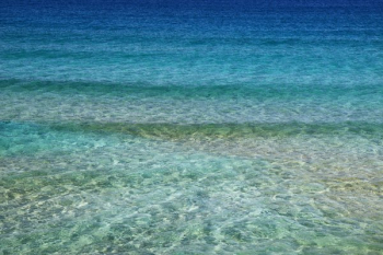 Green and Blue Body of Water Under Blue Sky Green and Blue Body of Water Under Blue Sky
