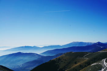 Green and Blue Fog Covered Mountains Under Blue Sky Green and Blue Fog Covered Mountains Under Blue Sky