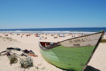 green boat on seashore green boat on seashore