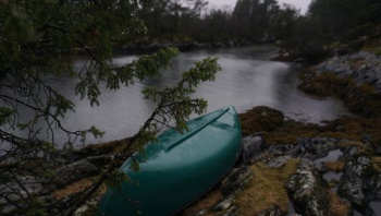 green kayak on rocky river green kayak on rocky river