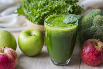 Green Liquid Fruit Juice on Glass Beside Apples