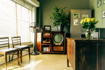 grey pedestal fan near brown wooden rack inside house grey pedestal fan near brown wooden rack inside house