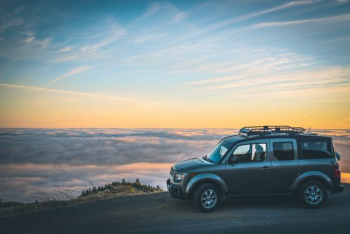 grey SUV beside sea of cloud grey SUV beside sea of cloud