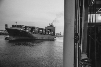 Greyscale Photo of Cargo Ship on Ocean Greyscale Photo of Cargo Ship on Ocean