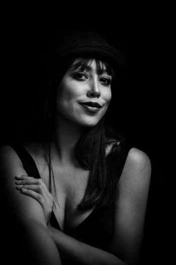 Greyscale Photo of Woman Wearing Tank Top and Hat Greyscale Photo of Woman Wearing Tank Top and Hat