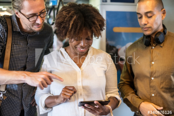 Group of diverse people using a smartphone Group of diverse people using a smartphone