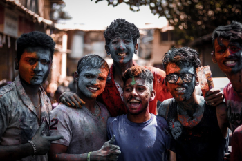 Group of men with faces and body covered with coloured powder Group of men with faces and body covered with coloured powder