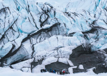 group of mountaineers hiking on snowy mountain group of mountaineers hiking on snowy mountain