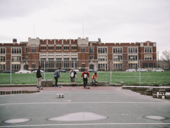 group of people near brown building group of people near brown building