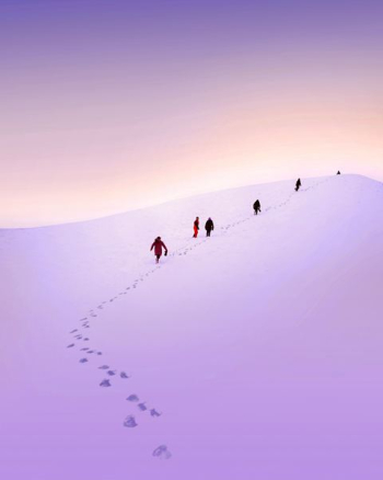 group of people walking snow field group of people walking snow field