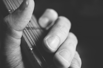 Guitarist hand playing guitar closeup 2 Guitarist hand playing guitar closeup 2