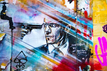gun pointed on man's eye painting