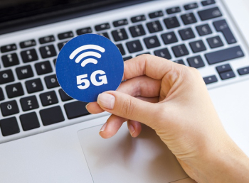 Hand holding 5g sticker above laptop Free Photo Hand holding 5g sticker above laptop Free Photo