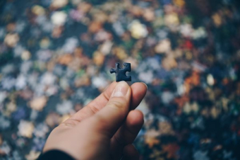 Hand Holding Puzzle Piece Hand Holding Puzzle Piece