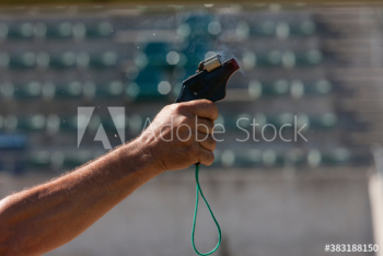 Hand holding track and field starting gun Hand holding track and field starting gun