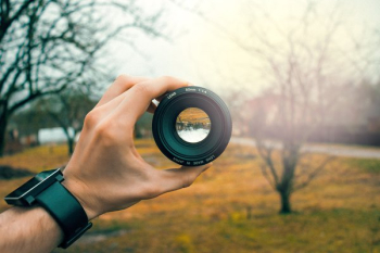 Hand Holds Camera Lens Hand Holds Camera Lens