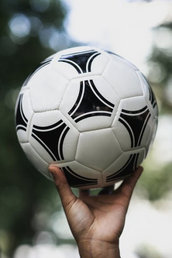 Hand Holds Up Soccer Ball Hand Holds Up Soccer Ball