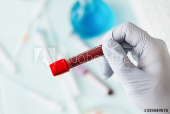 Hand of doctor holding a blood test tube during covid-19 outbreak Hand of doctor holding a blood test tube during covid-19 outbreak