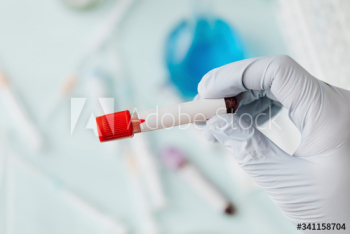 Hand of doctor holding a blood test tube during covid-19 outbreak Hand of doctor holding a blood test tube during covid-19 outbreak