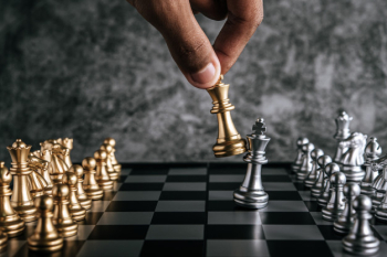 Hand of man playing chess for business planning and comparison of metaphor, selective focus Free Photo