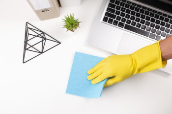 Hand wiping office desk Free Photo