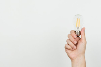Hand With Lightbulb On White