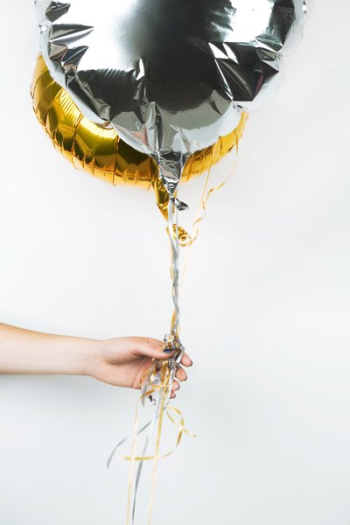 Hand With Metallic Balloons Hand With Metallic Balloons