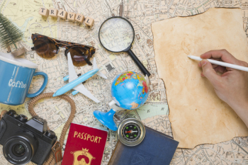 Hand writing next to travel elements