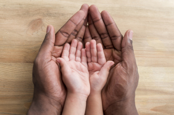 Hands of father and child on wooden table Hands of father and child on wooden table