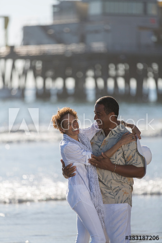 Happy active senior couple hugging on sunny ocean beach Happy active senior couple hugging on sunny ocean beach