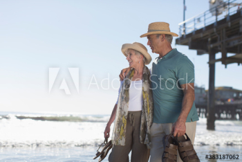 Happy active senior couple on sunny ocean beach Happy active senior couple on sunny ocean beach