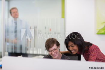 Happy businesswomen at computer in office Happy businesswomen at computer in office