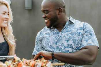 Happy couple preparing barbeque skewers Happy couple preparing barbeque skewers