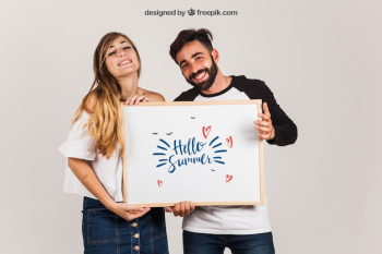 Happy couple presenting whiteboard Happy couple presenting whiteboard