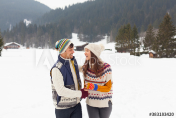 Happy couple walking in snowy landscape Happy couple walking in snowy landscape
